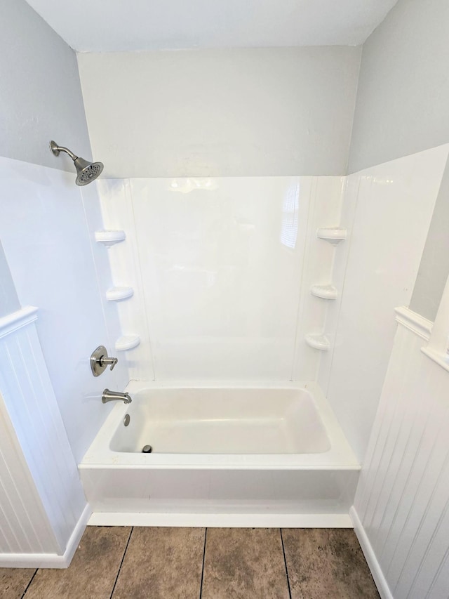 bathroom featuring shower / washtub combination and tile patterned flooring