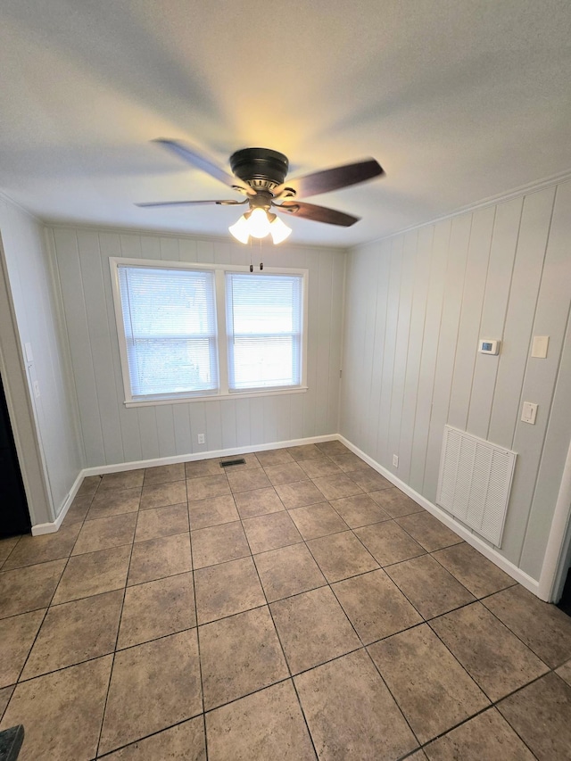 spare room with tile patterned floors and ceiling fan