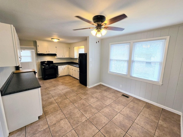 kitchen featuring light tile patterned flooring, ceiling fan, white cabinets, and black appliances