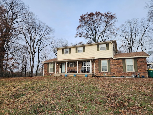 view of front of house with covered porch and a front yard