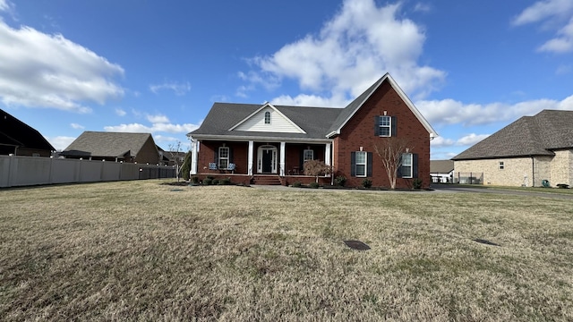 view of front of house with a porch and a front yard