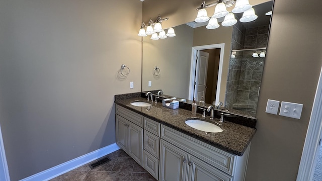 bathroom featuring tile patterned flooring, vanity, and a shower with door