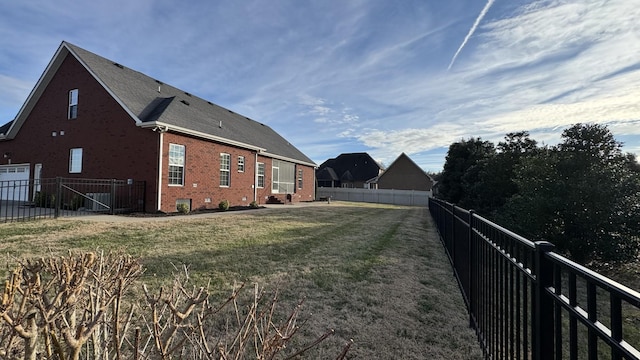 view of side of home with a lawn