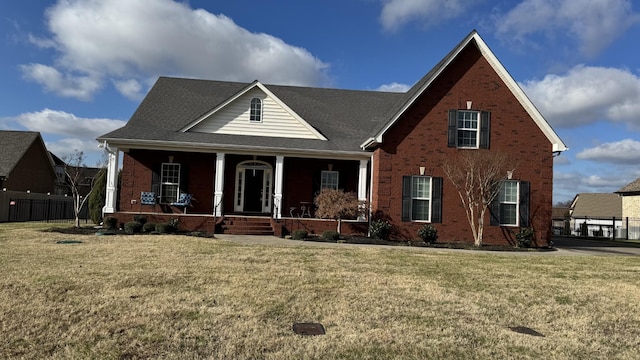 view of front of house with a porch and a front lawn