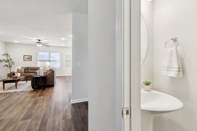 bathroom with ceiling fan and wood-type flooring