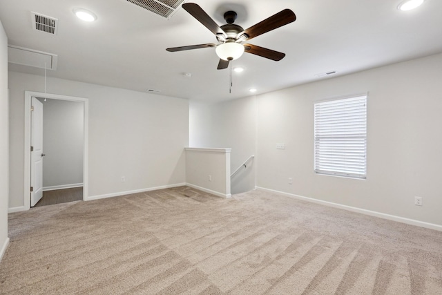 empty room featuring light carpet and ceiling fan