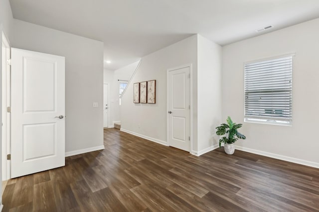 spare room with dark hardwood / wood-style floors