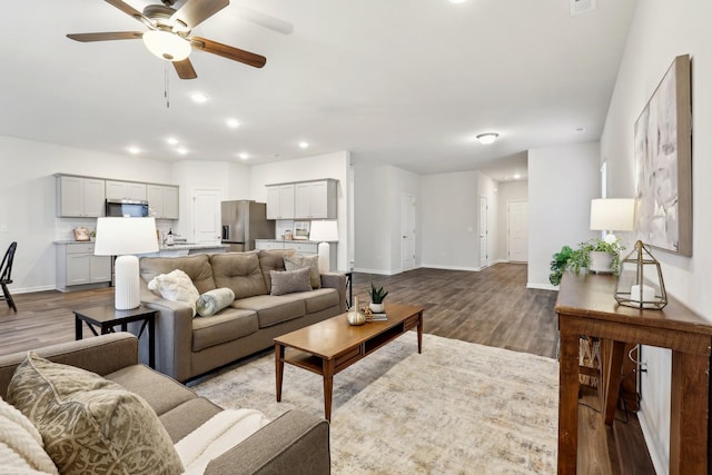 living room with ceiling fan and light wood-type flooring