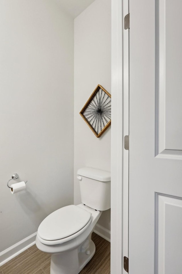 bathroom with hardwood / wood-style floors and toilet