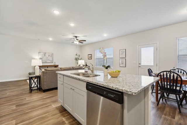 kitchen with white cabinetry, sink, an island with sink, and stainless steel dishwasher