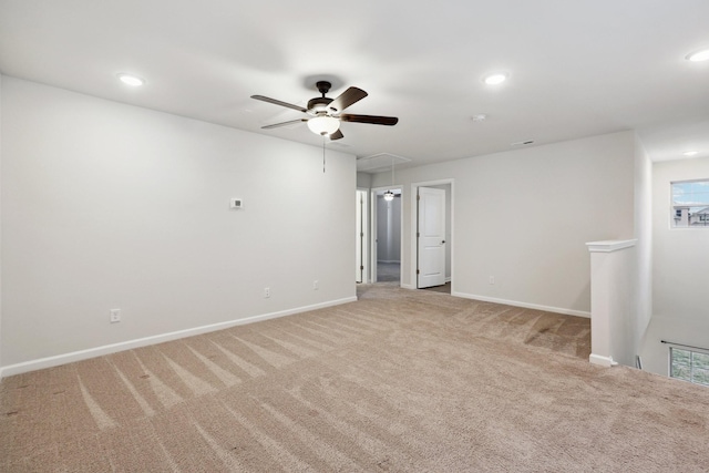 carpeted spare room with ceiling fan