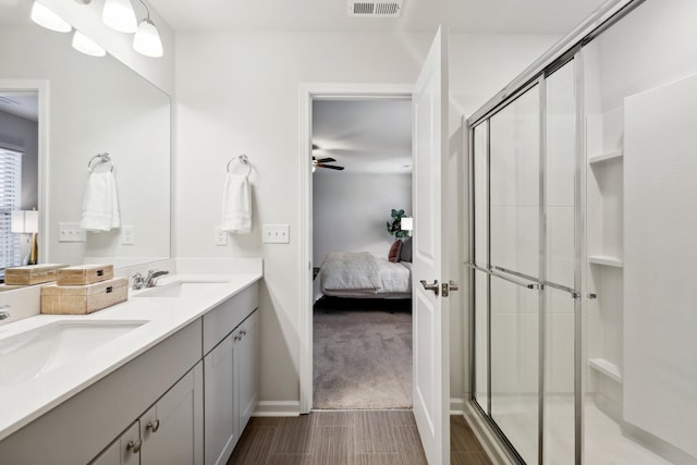 bathroom with vanity, walk in shower, and ceiling fan