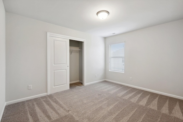 unfurnished bedroom with carpet and a closet