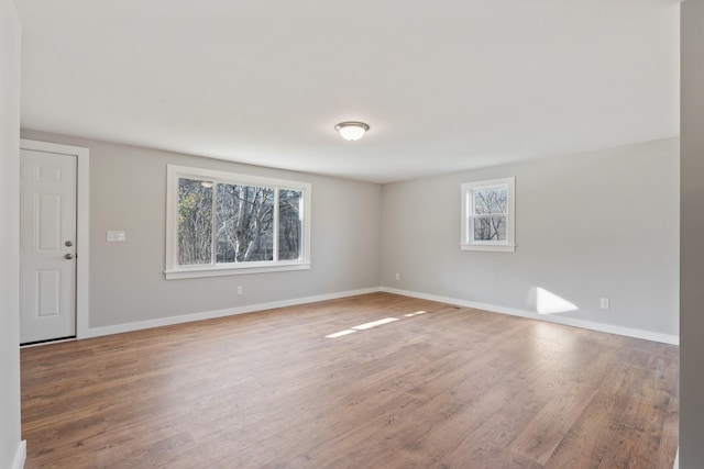 spare room featuring wood-type flooring