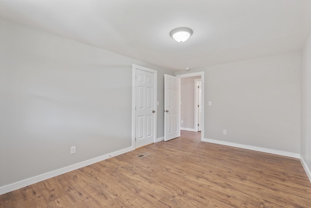 spare room featuring wood-type flooring