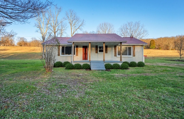 ranch-style home featuring a porch and a front yard