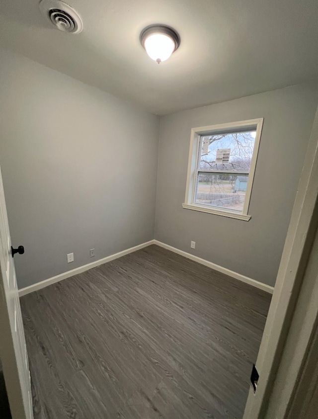 spare room with dark hardwood / wood-style flooring