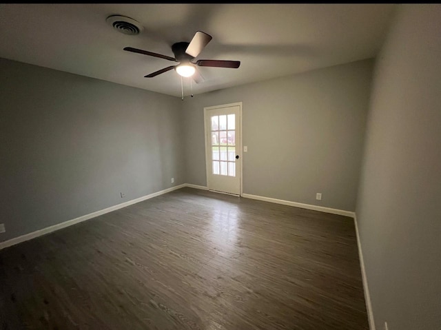 spare room with ceiling fan and dark hardwood / wood-style flooring