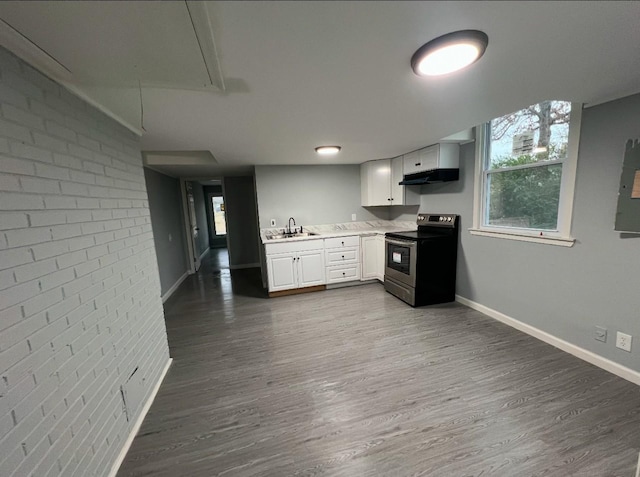 kitchen featuring white cabinetry, stainless steel range with electric stovetop, plenty of natural light, and sink