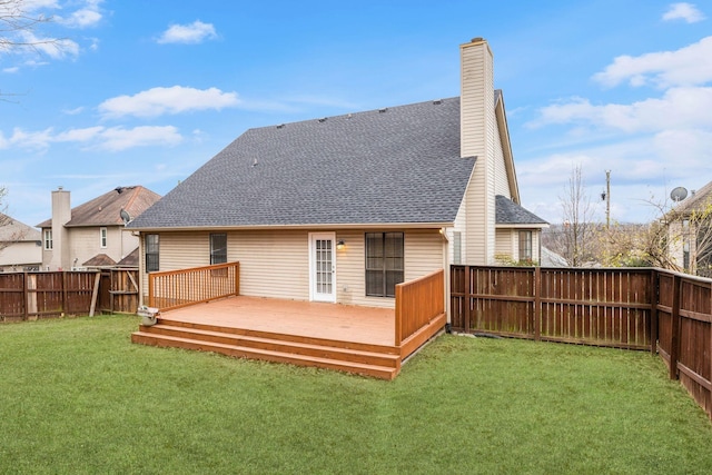 back of house with a lawn and a deck