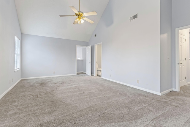 unfurnished room with ceiling fan, light carpet, and high vaulted ceiling