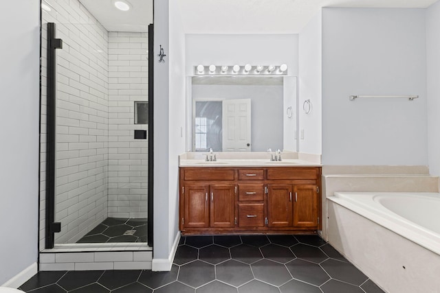 bathroom with tile patterned floors, vanity, and independent shower and bath