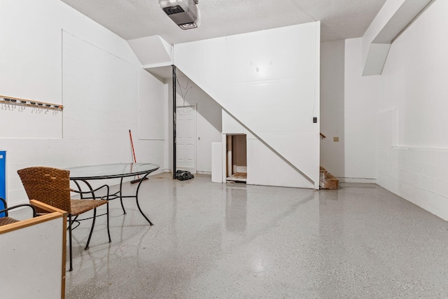 unfurnished dining area with a textured ceiling