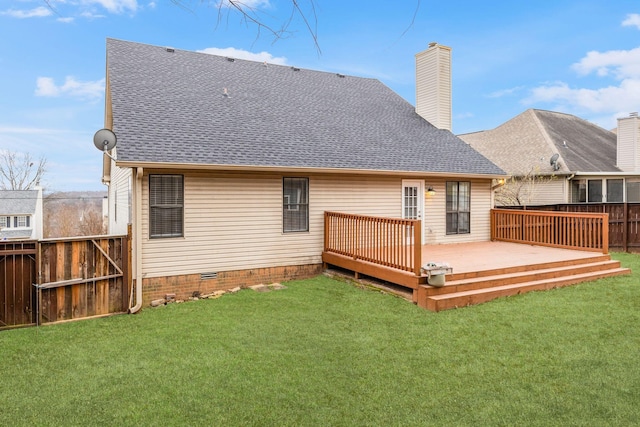 rear view of property with a deck and a yard