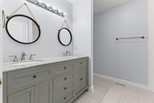 bathroom with tile patterned flooring and vanity