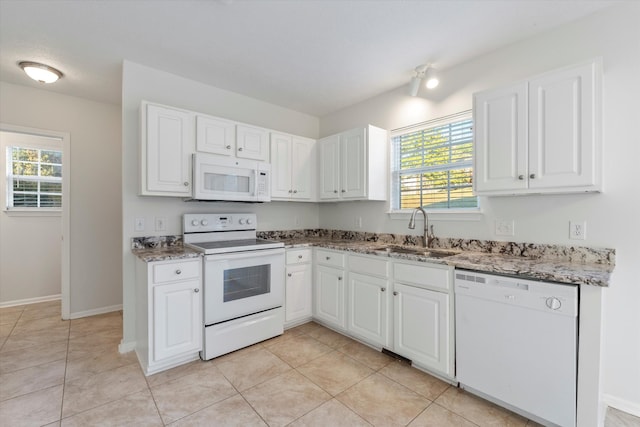 kitchen featuring white cabinets, white appliances, light tile patterned flooring, and sink