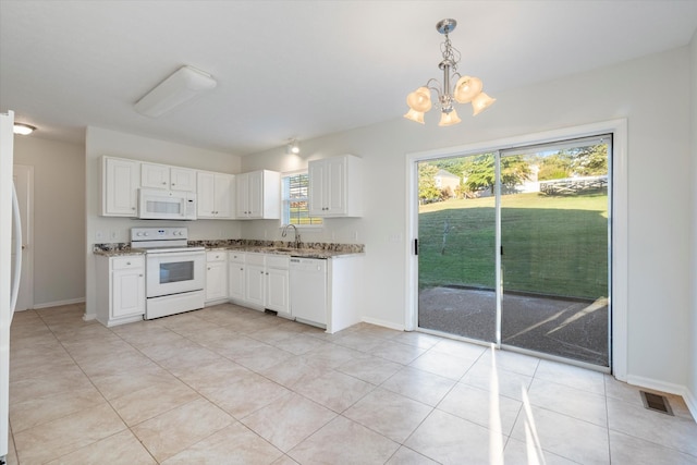 kitchen with white appliances, white cabinets, sink, decorative light fixtures, and a chandelier