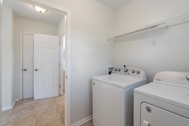 washroom featuring separate washer and dryer and light tile patterned floors