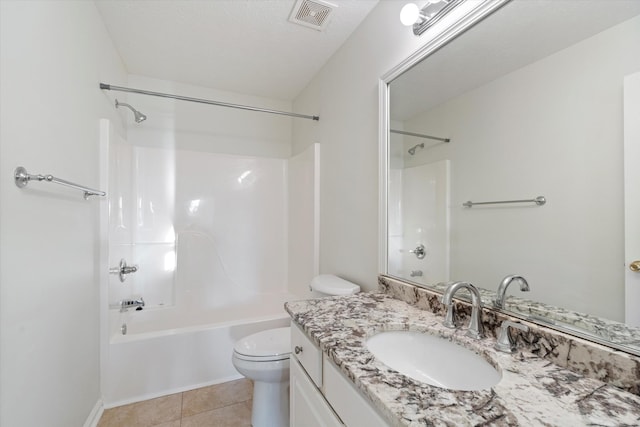 full bathroom with tile patterned floors, a textured ceiling,  shower combination, toilet, and vanity