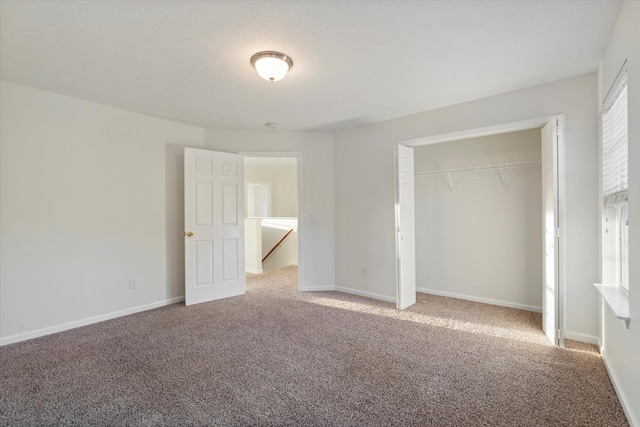 unfurnished bedroom with carpet flooring and a closet