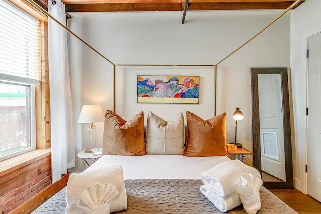 bedroom featuring hardwood / wood-style floors and multiple windows