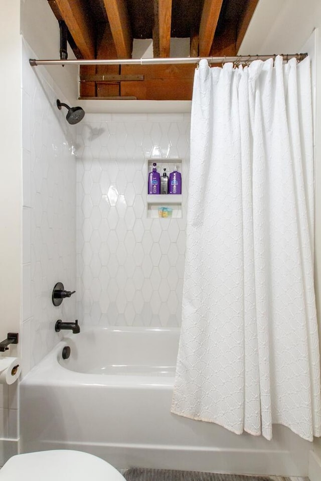 bathroom with toilet and shower / tub combo with curtain