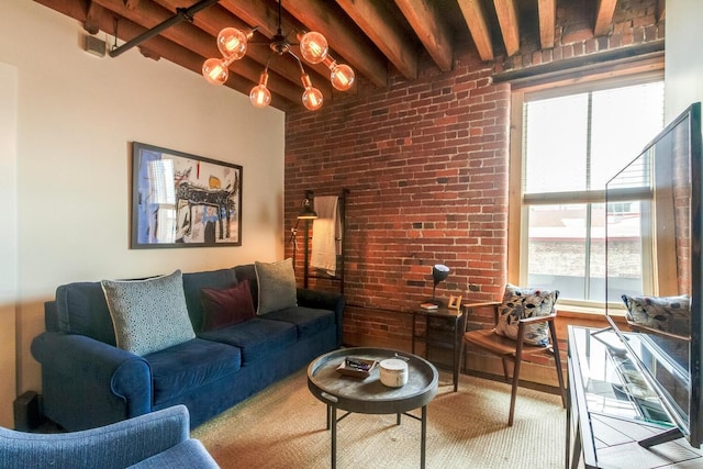 living room with beamed ceiling, a wealth of natural light, and brick wall