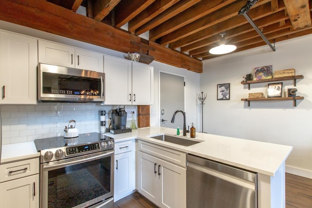 kitchen featuring white cabinets, sink, appliances with stainless steel finishes, and tasteful backsplash