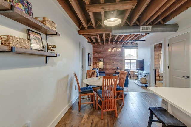 dining room with wood-type flooring and brick wall