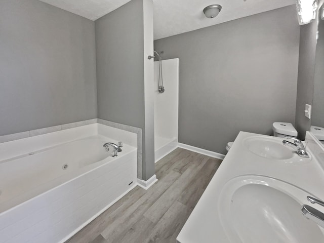 full bathroom featuring wood-type flooring, a textured ceiling, toilet, vanity, and shower with separate bathtub