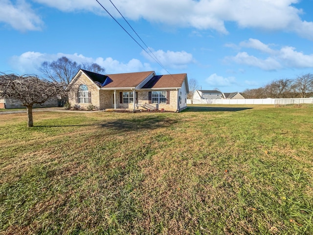 ranch-style house with a front lawn