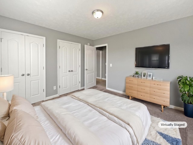 carpeted bedroom featuring two closets