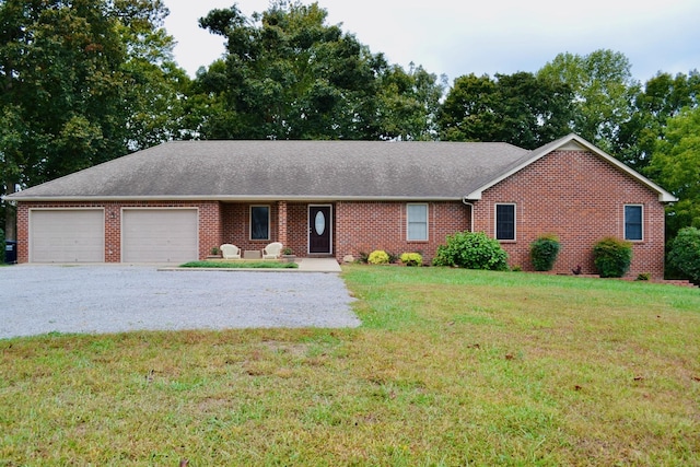 ranch-style house featuring a garage and a front lawn