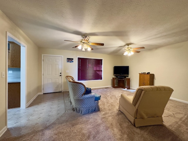 living room featuring ceiling fan, light colored carpet, and a textured ceiling