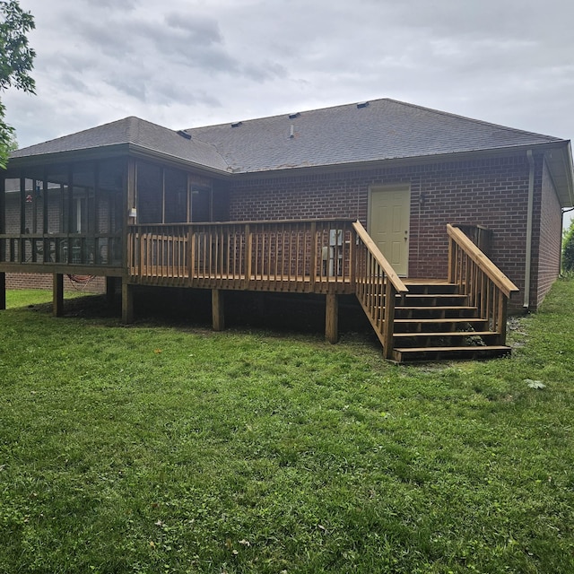 rear view of property with a lawn and a wooden deck