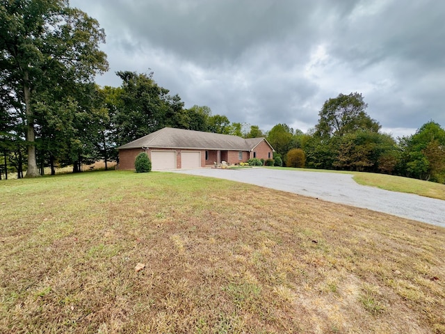 single story home featuring a front lawn and a garage