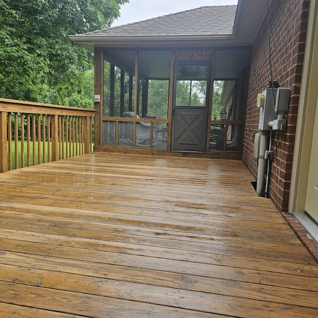 wooden deck with a sunroom