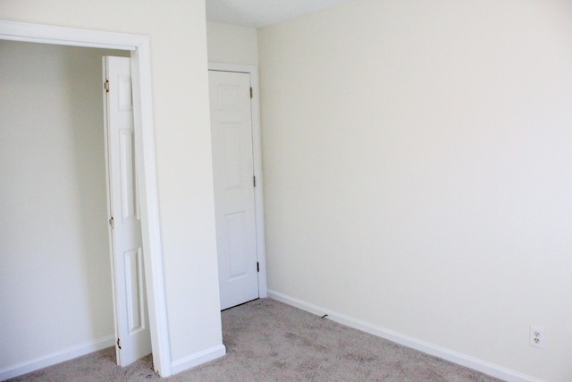 unfurnished bedroom featuring light colored carpet