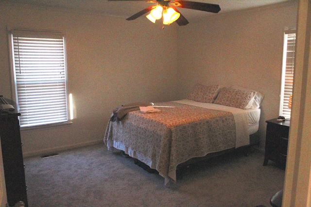 bedroom with ceiling fan and dark carpet