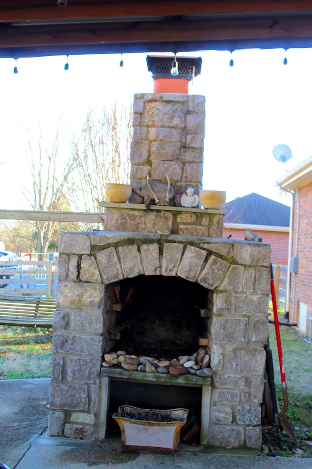 exterior details with an outdoor stone fireplace